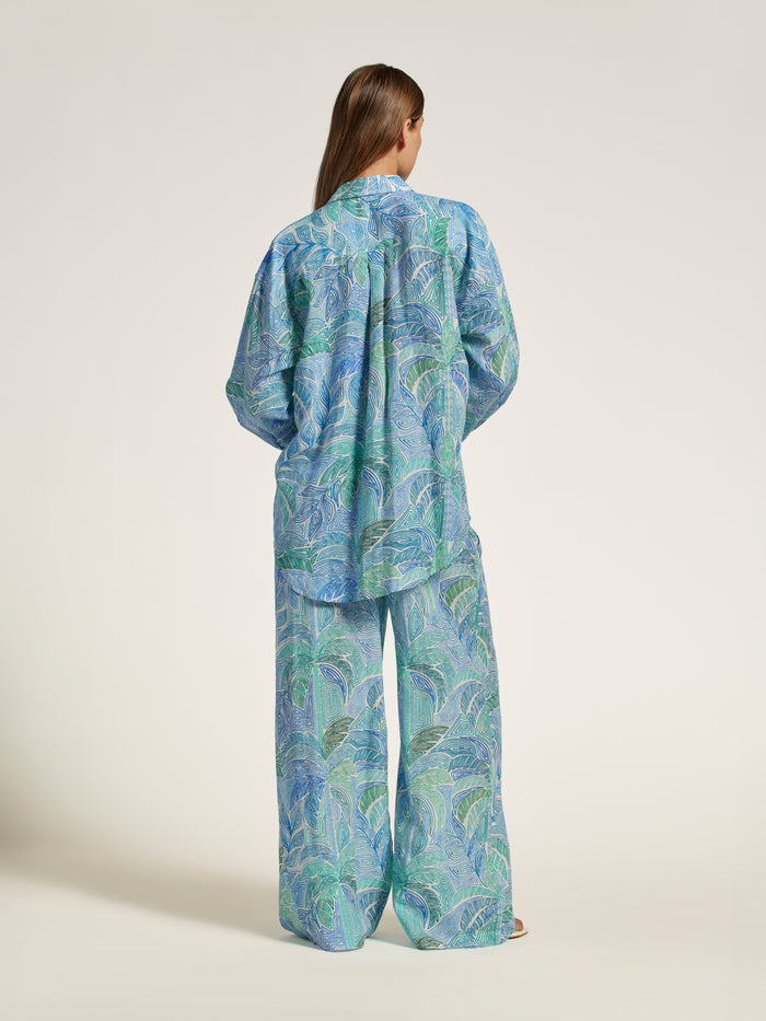 Blue-green leafy-pattern shirt, back view.