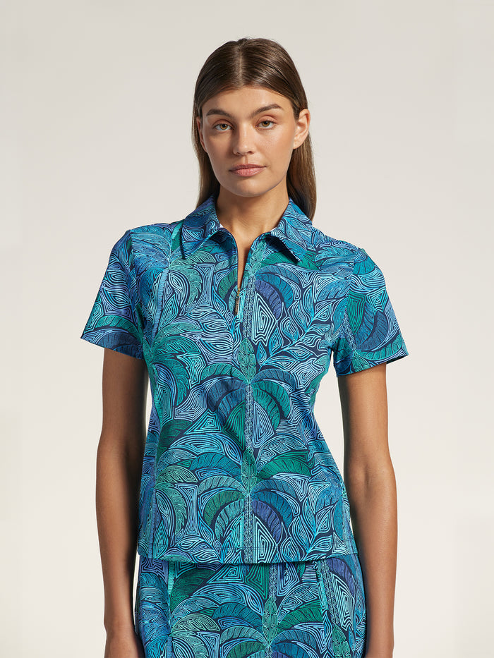 Blue and white geometric-print polo shirt and skirt set, front view against light background