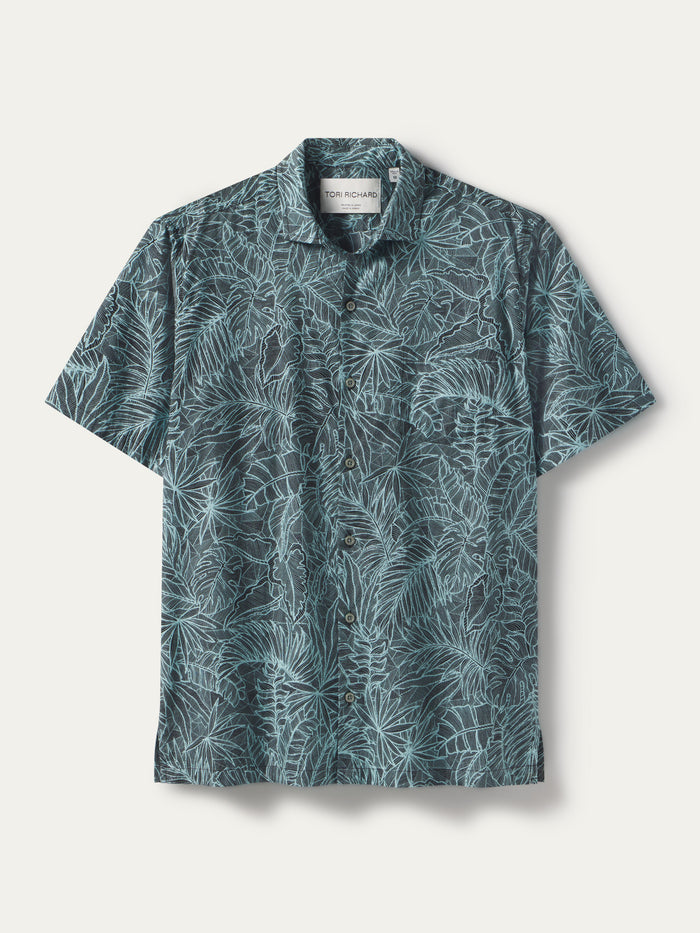 Teal tropical leaf-print short-sleeve cotton shirt, flat lay on white background{{/AltText}}.