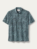 Teal tropical leaf-print short-sleeve cotton shirt, flat lay on white background{{/AltText}}.