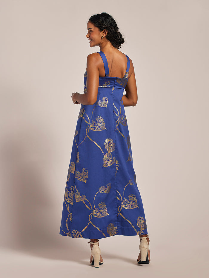 Gold leaf-patterned Love Note Tori Dress, back view, woman smiling over shoulder.
