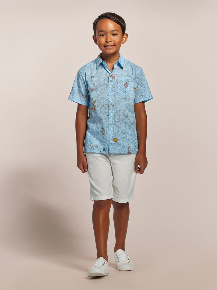Light blue floral-print short-sleeve shirt with white shorts and shoes, front view.