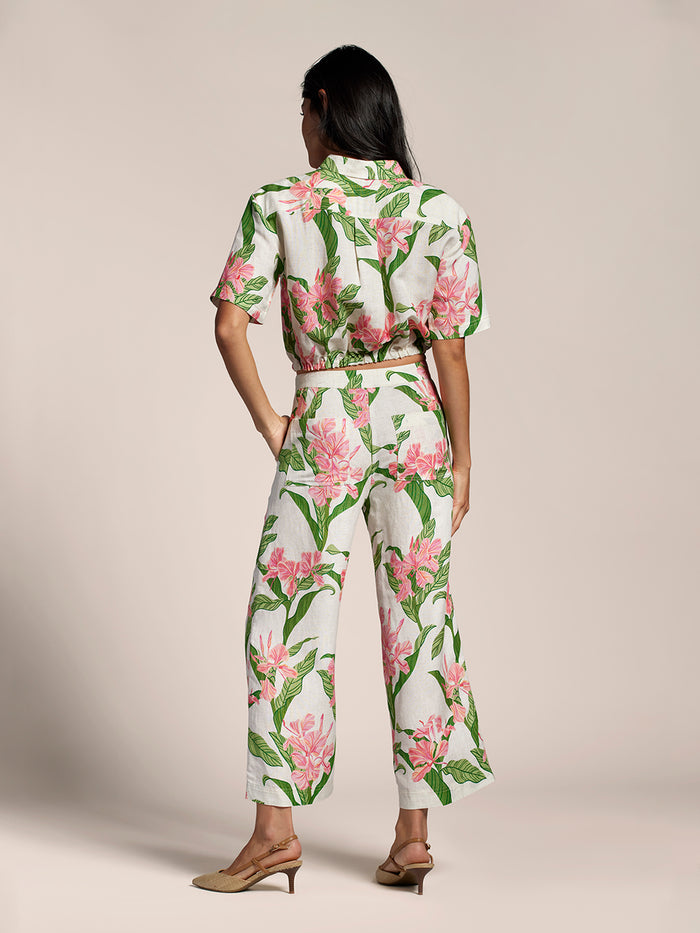 White Mariposa Selena top, plain sleeveless blouse, back view with model’s hands on hips.