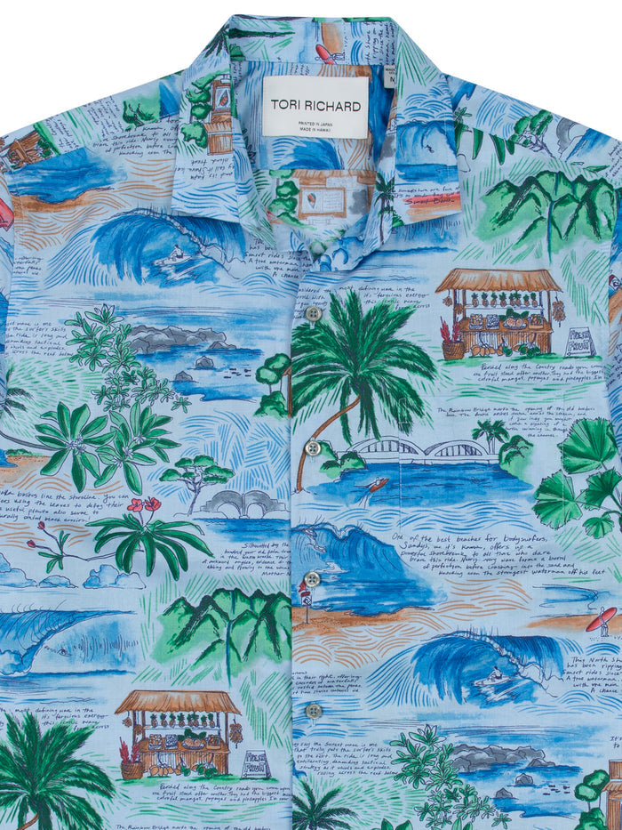 Blue multicolor island-scene print cotton short-sleeve shirt, front view.