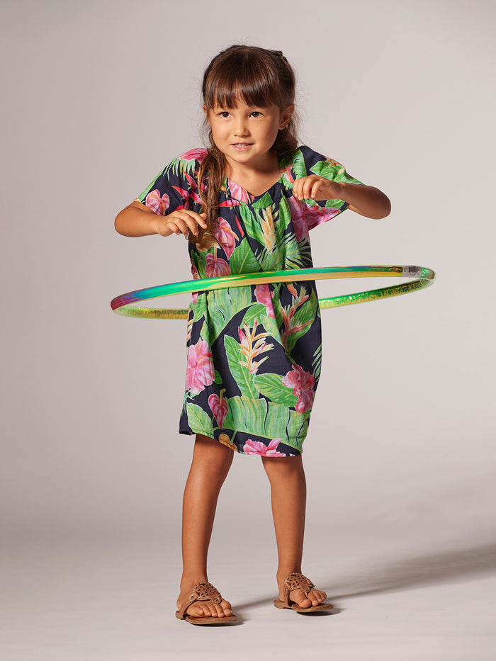 Navy floral-print sleeveless dress on young girl, side view with hula hoop.