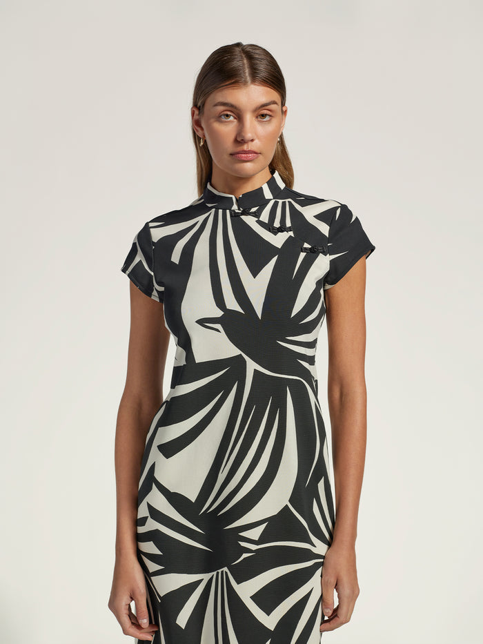 Black solid midi dress with mandarin collar, front view on woman, plain background (Images 1 & 2).