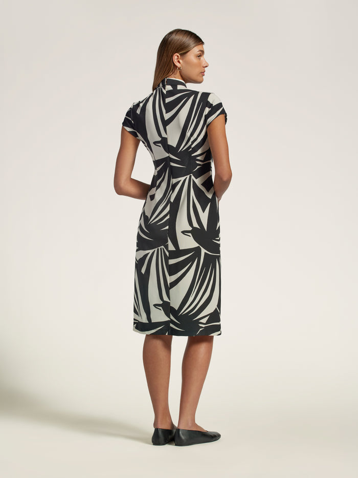 Black and white patterned midi dress with mandarin collar, back view.