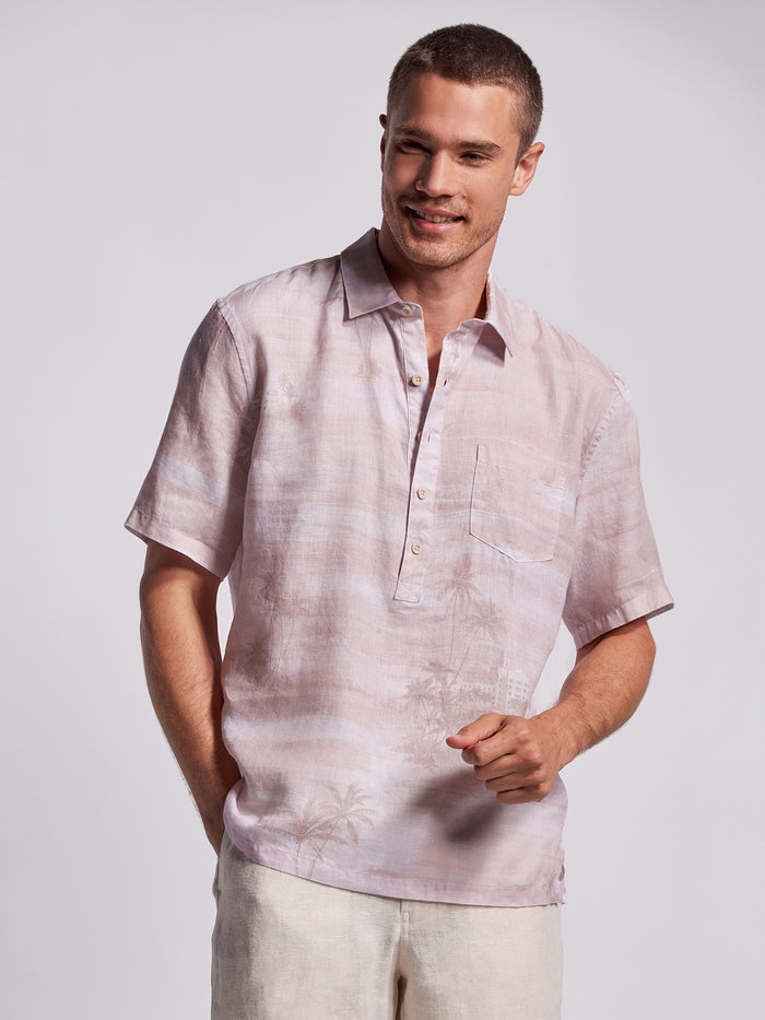 Pink palm-print half placket shirt, front view, with light pants (Image 1 & 2).