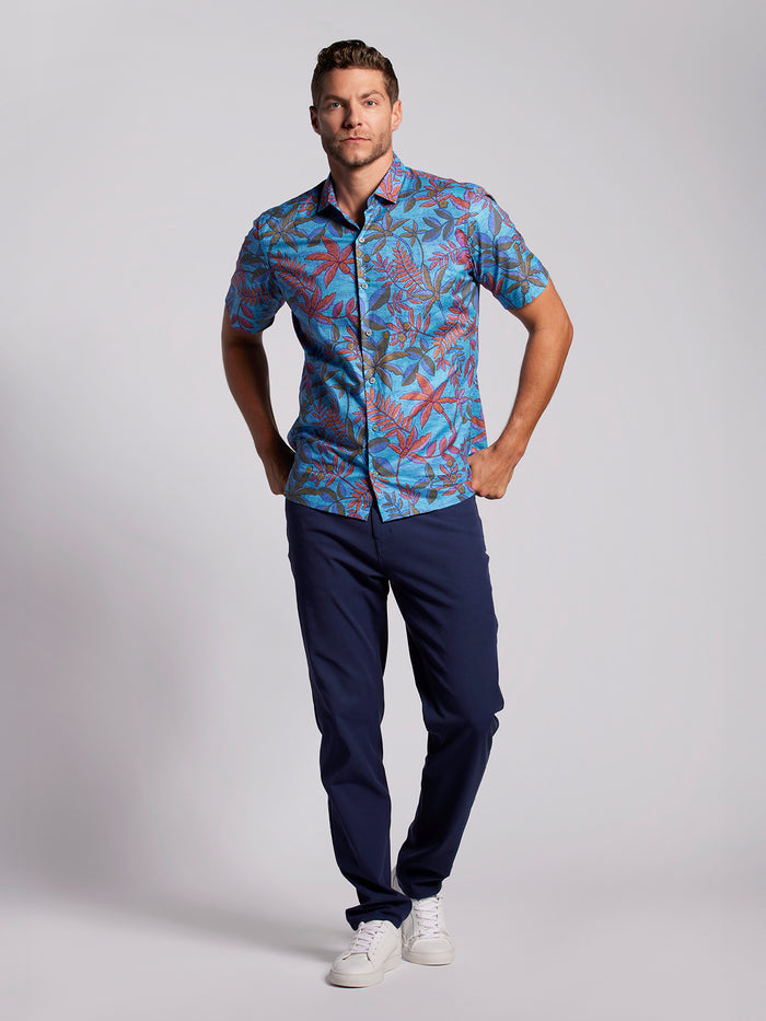 Blue floral short-sleeve shirt with navy pants, front view against plain background.