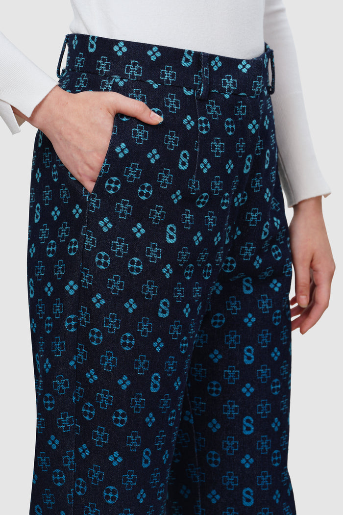 monogram denim pants in blue by buttonscarves monogram pattern detail