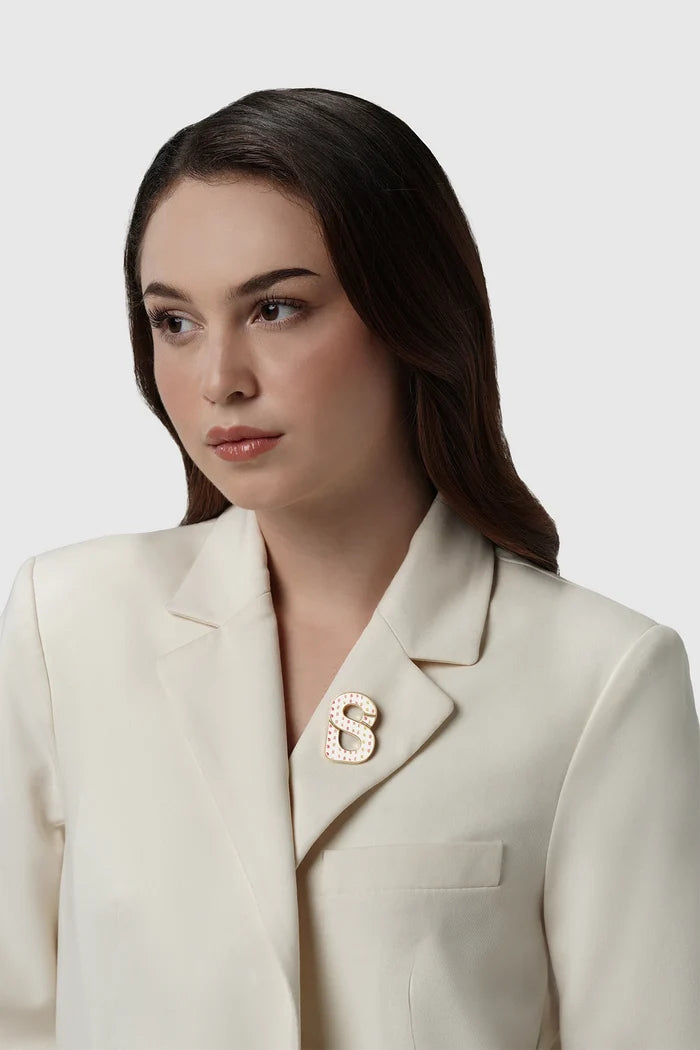 nagita brooch package in gliding gold by buttonscarves x nagita slavina signature b logo on blazer