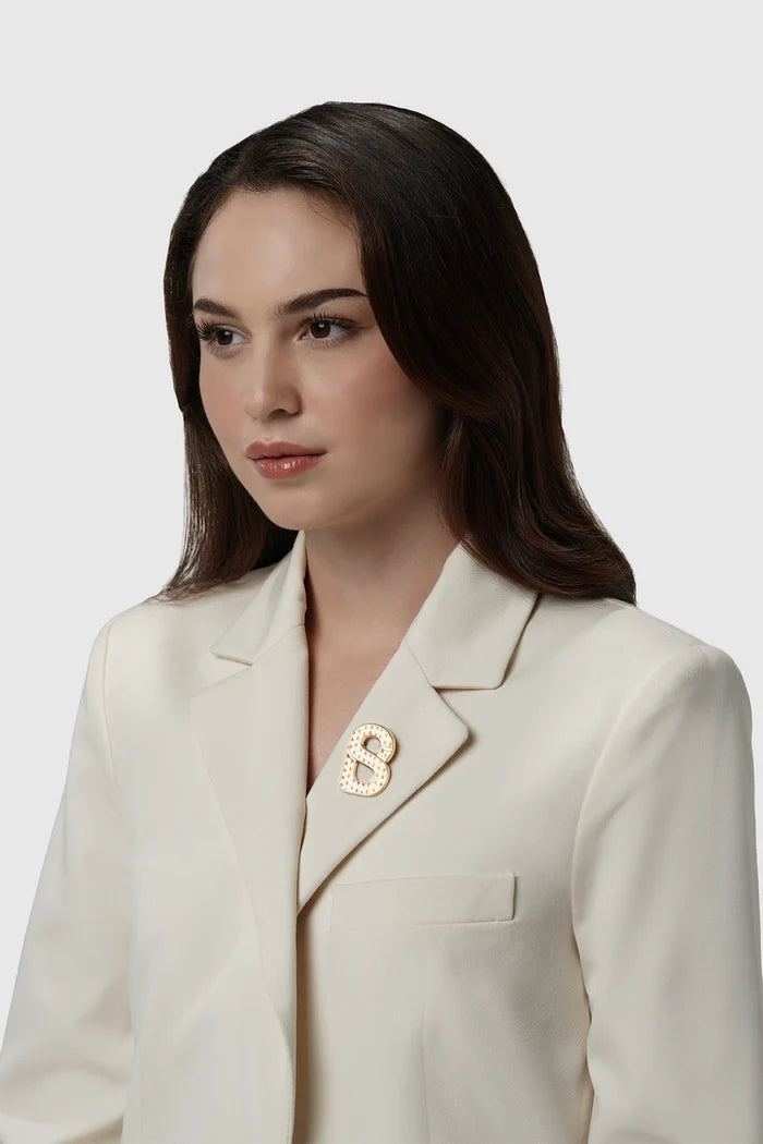 nagita brooch package in gold by buttonscarves x nagita slavina signature b logo on blazer