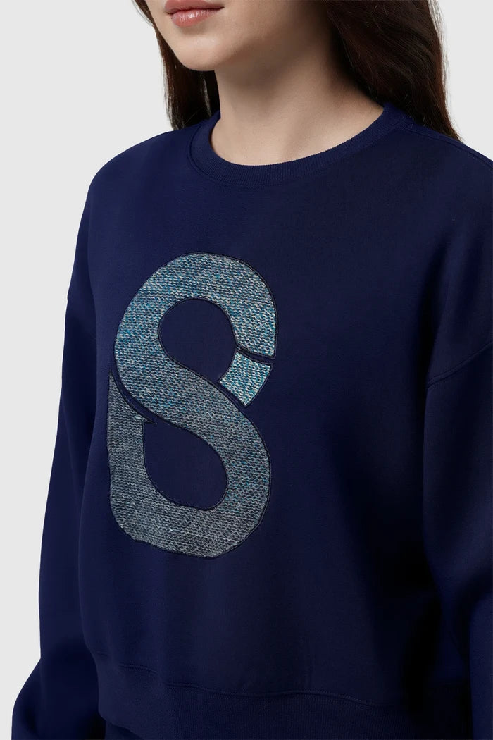 nagita sweatshirt in navy by buttonscarves x nagita slavina signature b embroidered logo detail