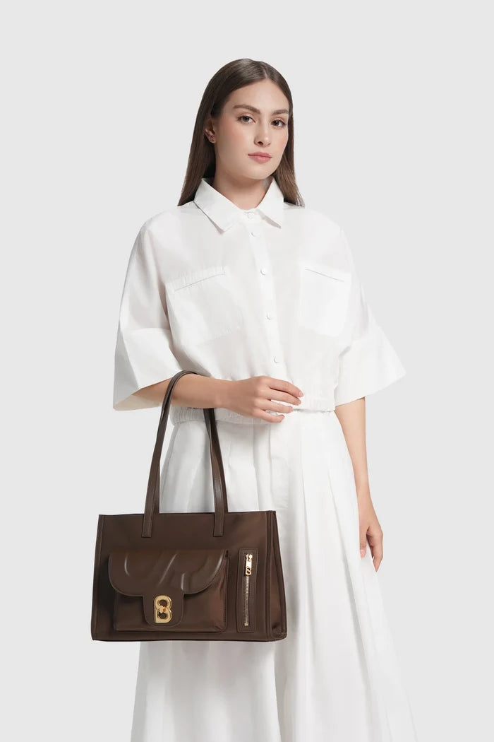 nara tote bag in brown by buttonscarves carried on wrist