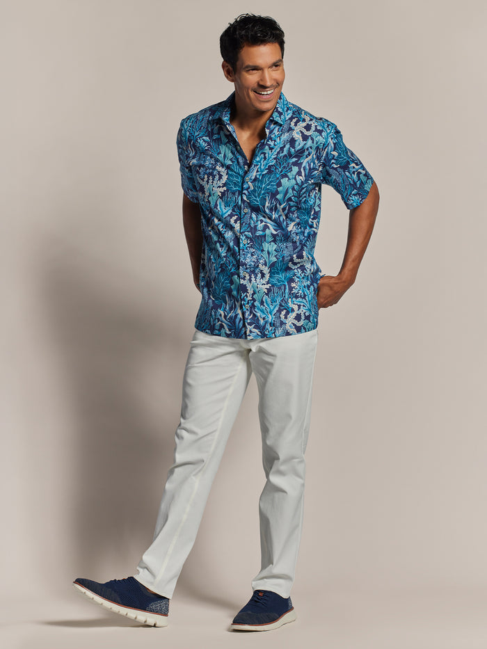 Blue Neptunes Garden print short-sleeve shirt and light pants, standing front view.