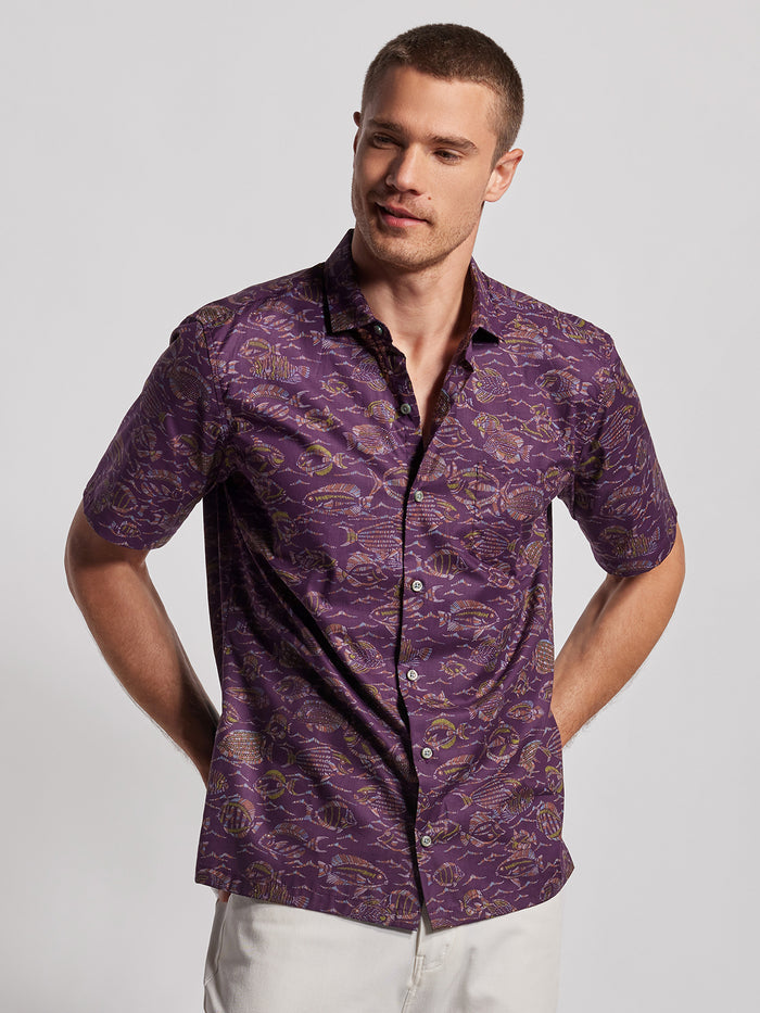 Blue and multicolor Night Dive print cotton shirt with light pants, side view (Images 1 & 2).