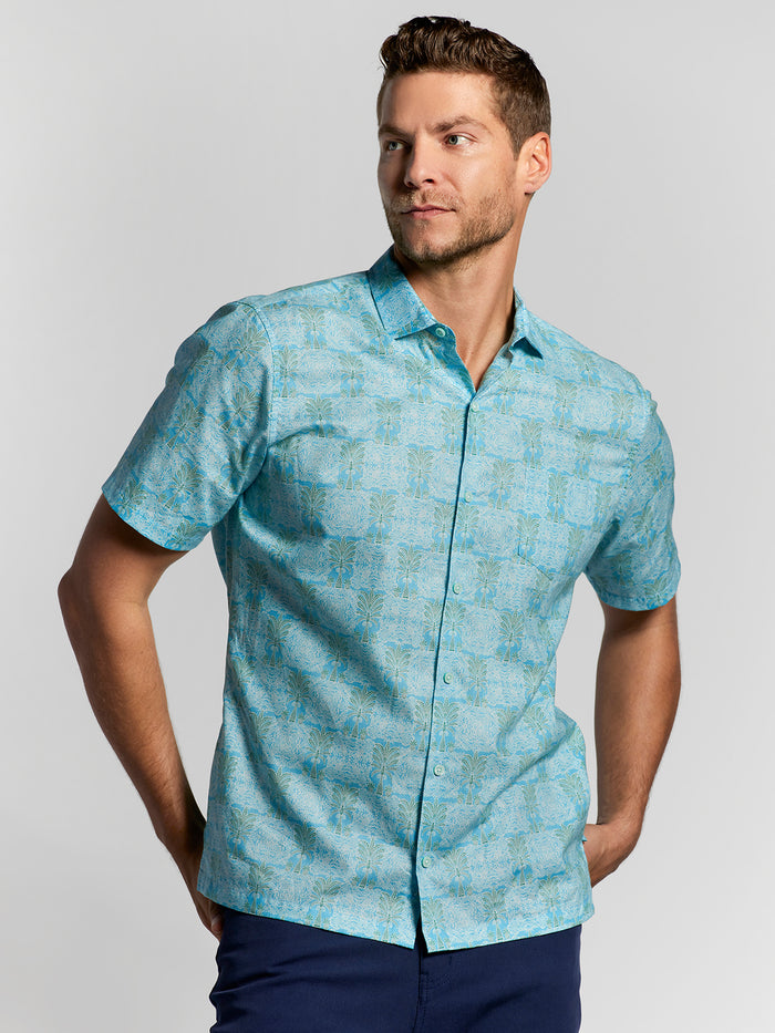 Light blue palm-print cotton short-sleeve shirt, front view.
