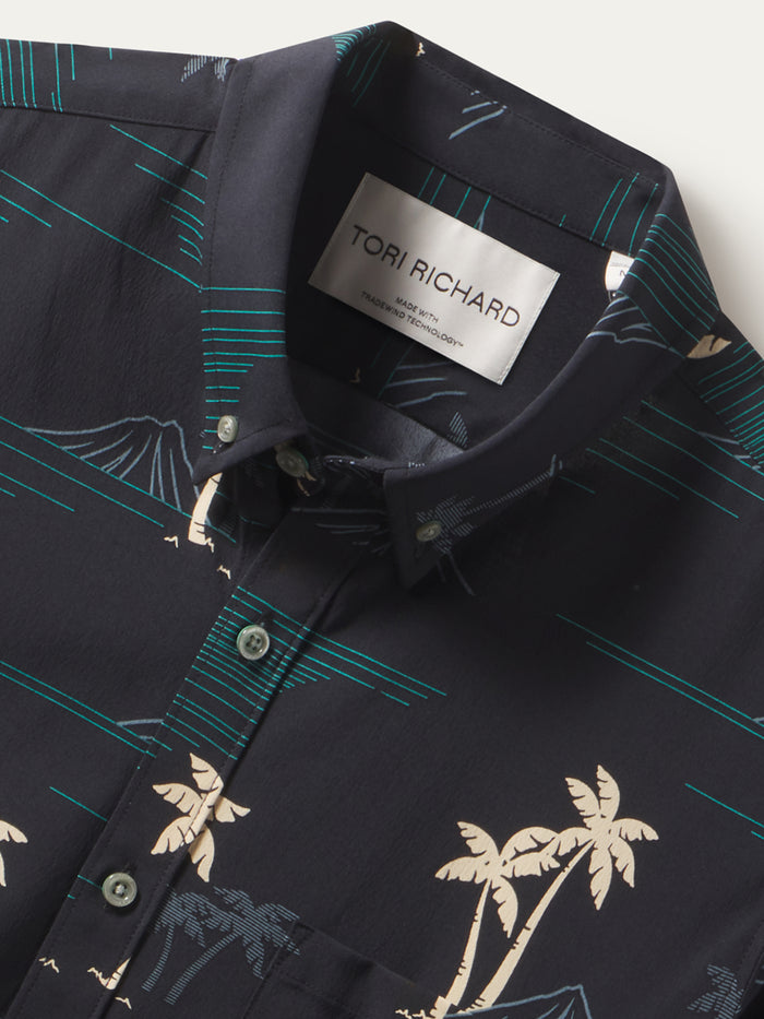 Black short-sleeve shirt with beige palm and teal mountain print, palm print, aloha shirt with button-down collar, front view.