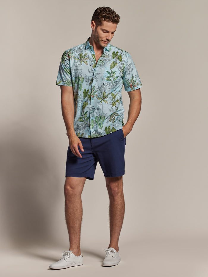 Navy graphic-print Observations T-shirt, solid navy shorts, and white sneakers, front view with casual stance.
