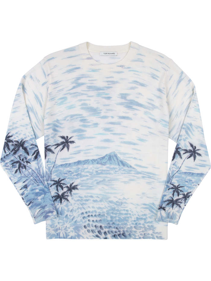 White Merino wool sweater with blue palm trees and mountain print, long sleeves, front view.