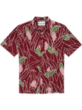 Red tropical floral-print short-sleeve cotton shirt with green leaves, flat lay front view.