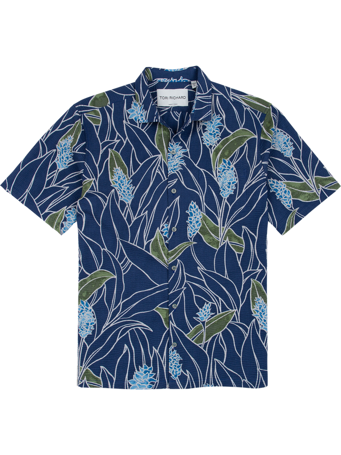 Blue short-sleeve shirt with green and light blue floral print, flat lay front view.