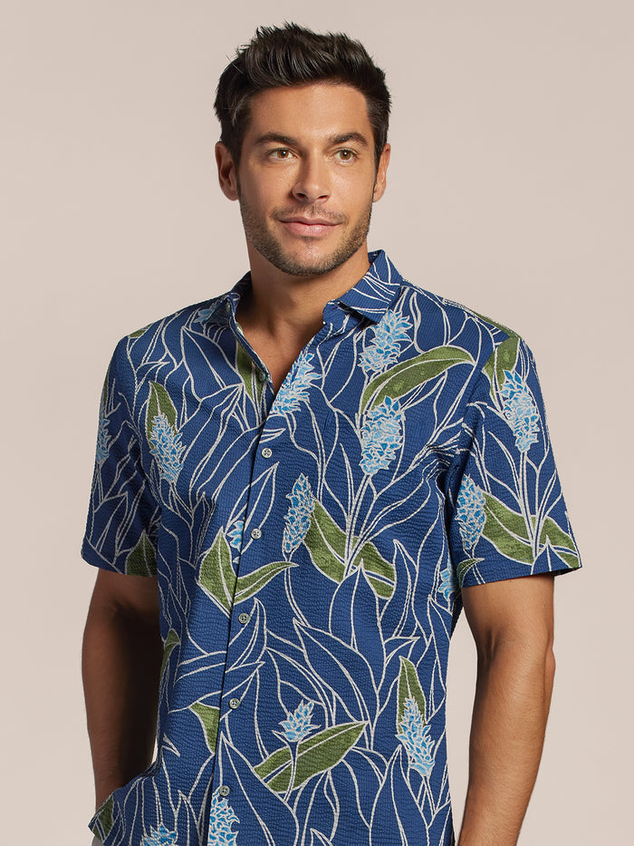 Blue cotton shirt with green and white leaf print, front view of a man.