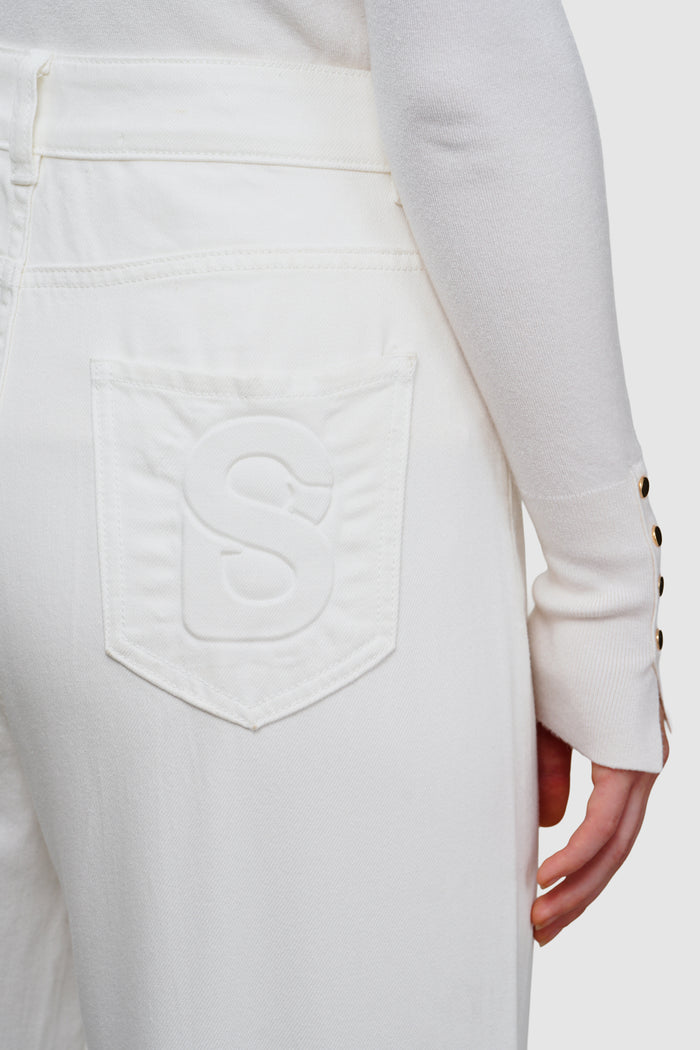 olivia denim pants in white by buttonscarves signature b detail