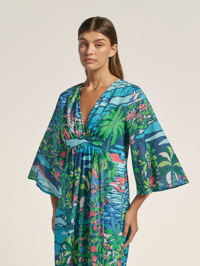 Opalescent solid caftan dress with wide sleeves and deep v-neckline, front view.