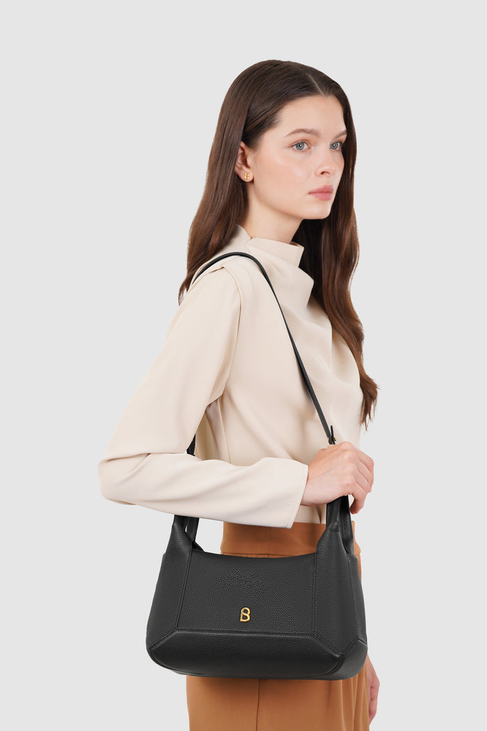 origa flex shoulder bag in black by buttonscarves carried on shoulder