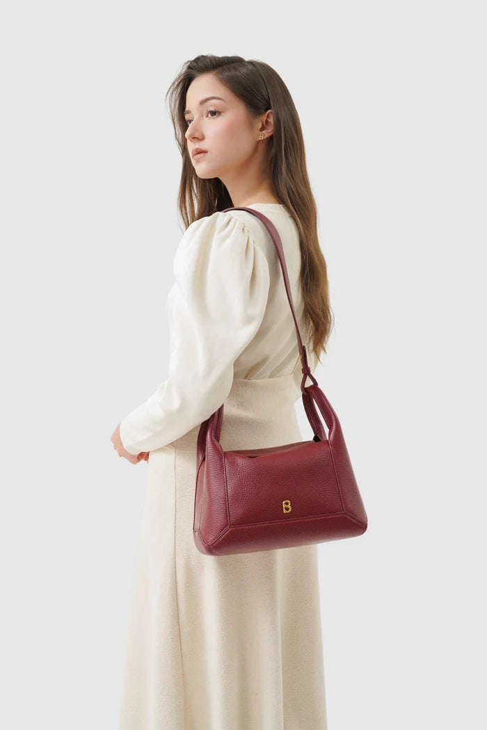 origa flex shoulder bag medium in cranberry by buttonscarves carried on shoulder