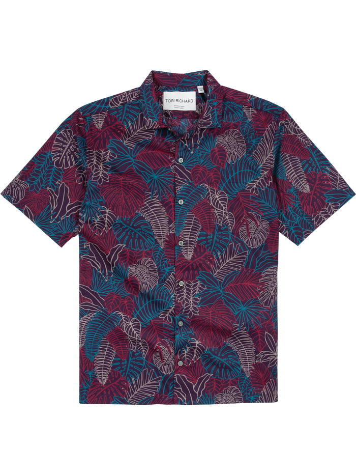 Red, blue, and white tropical leaf-print short-sleeve shirt, flat lay view.