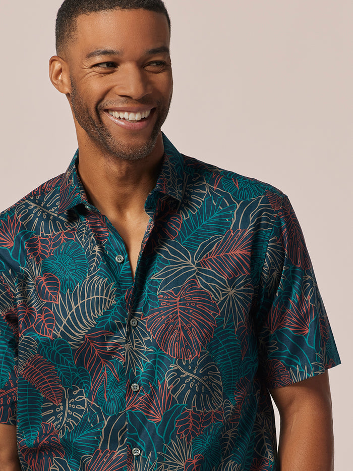 Multicolor tropical leaf-print short-sleeve cotton shirt, front view on man.