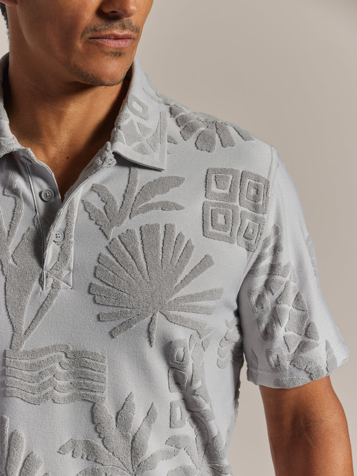 Light Grey jacquard-patterned polo shirt with raised nature details, mid-torso view.