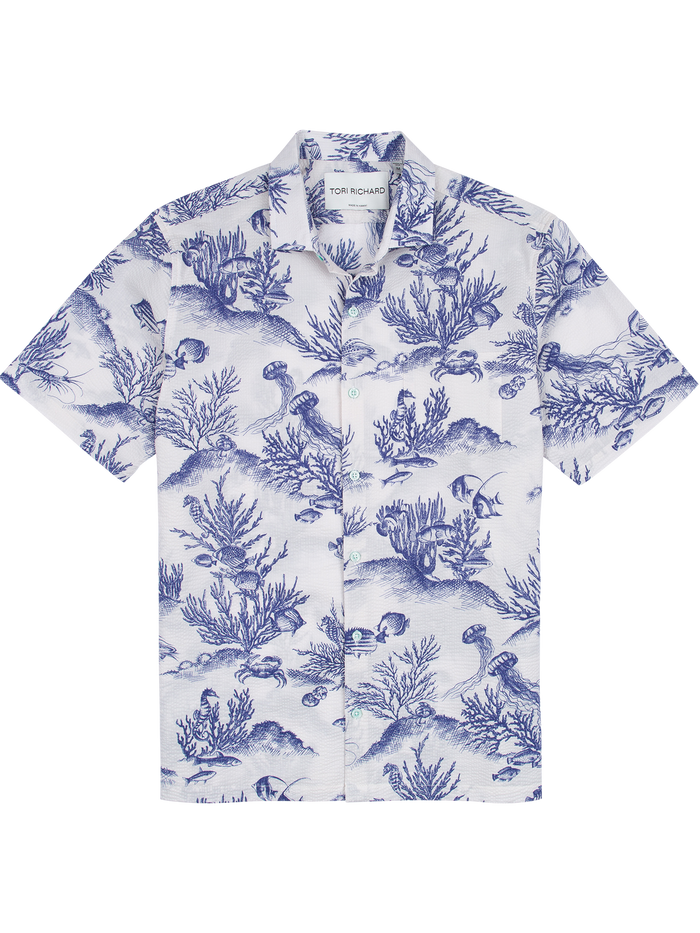 Front view of white and blue fish-print short-sleeve shirt.