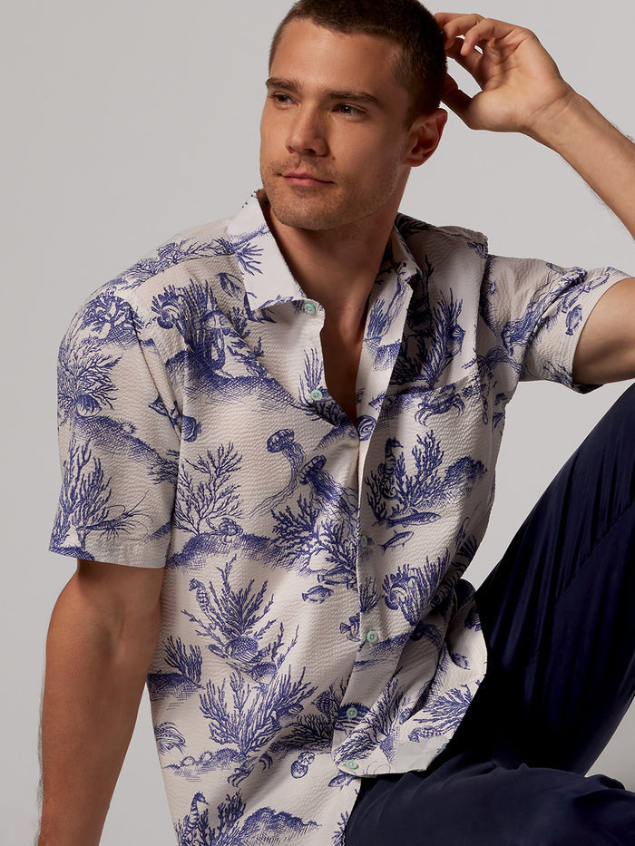 White and blue seaweed-print cotton short-sleeve shirt, side view.