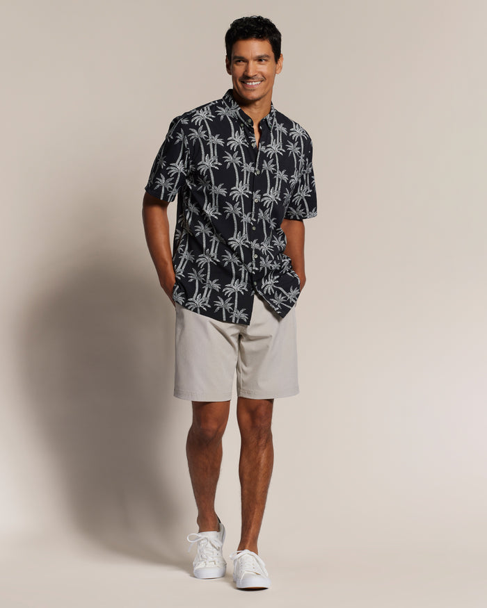 Black palm-print short-sleeve shirt with light shorts, front view shown in both images.