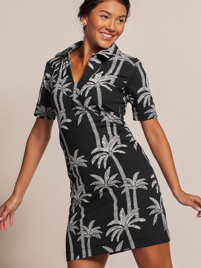 White palm-print Phoenix dress with quarter sleeves and UPF fabric, shown on a model in a front view.