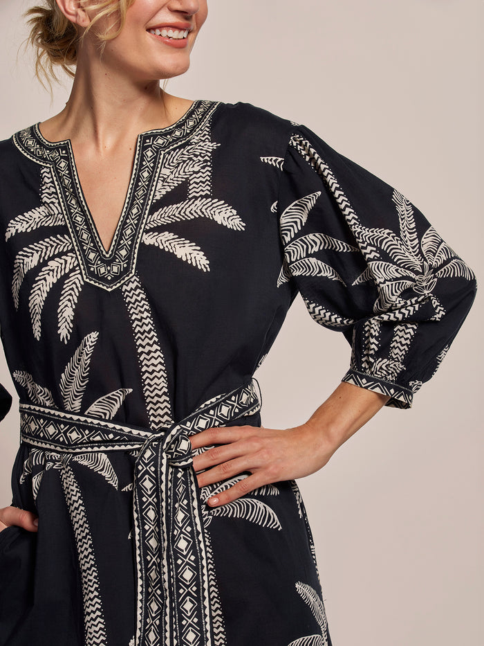 Black and White palm tree-print midi caftan with v-neck and belted waist, front view.
