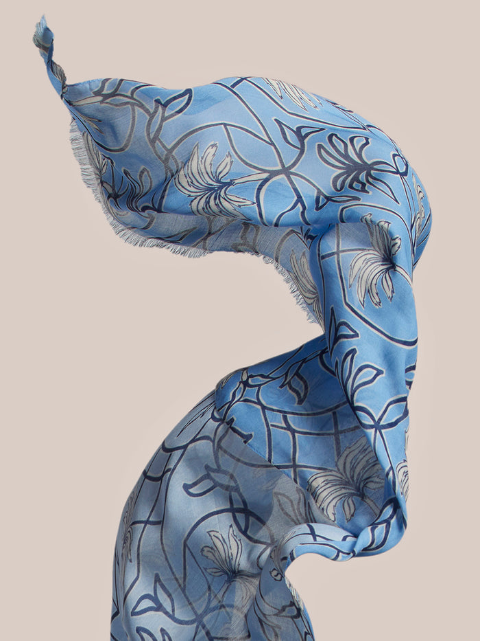 Blue floral-print viscose scarf, lightweight, shown against a beige background.