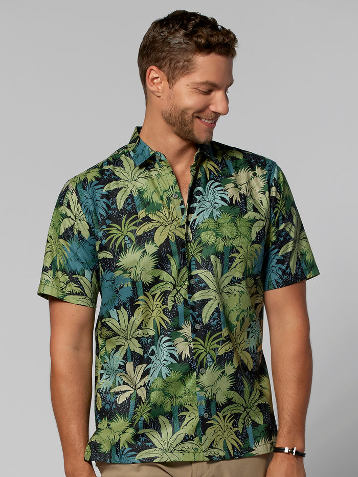 Light gray palm-leaf print cotton short-sleeve shirt, man looking down, front view.