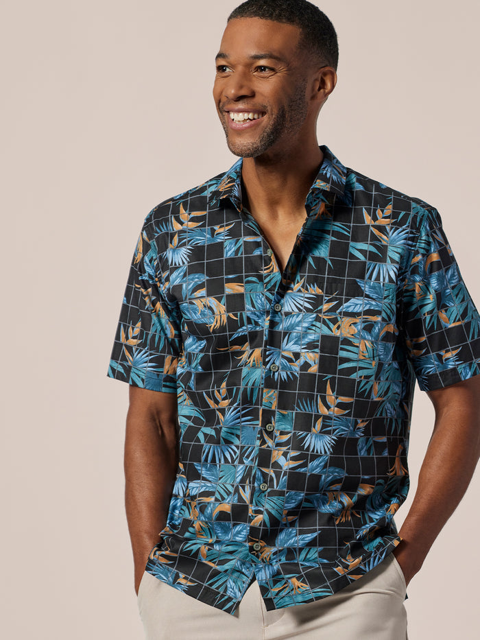 Blue and orange tropical-print short-sleeve shirt, front view on smiling man.