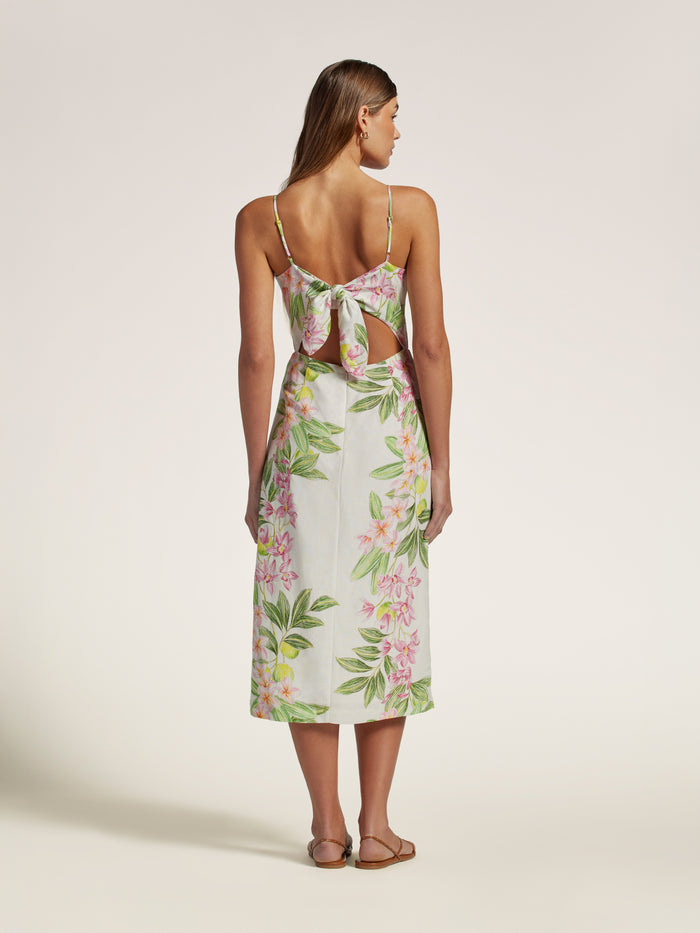 Blue and white floral linen midi dress with adjustable straps and back bow, shown from the back.