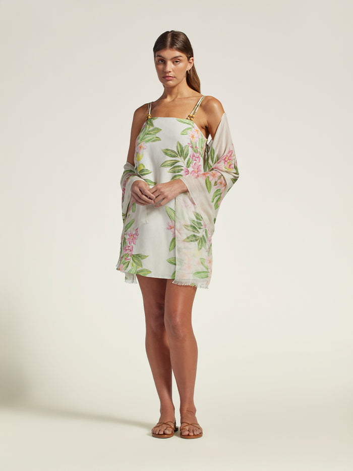 White and multicolor abstract-print scarf cover-up, full-body front view with sandals in both images.