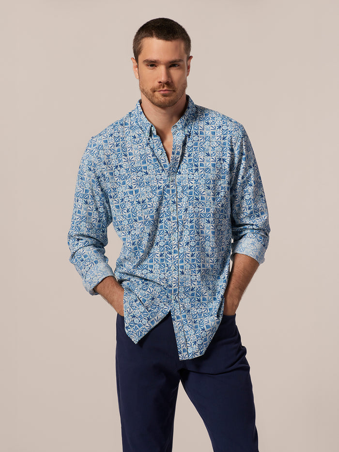 Blue and white geometric long-sleeve shirt Tradewind Technology shirt with navy pants, front view.