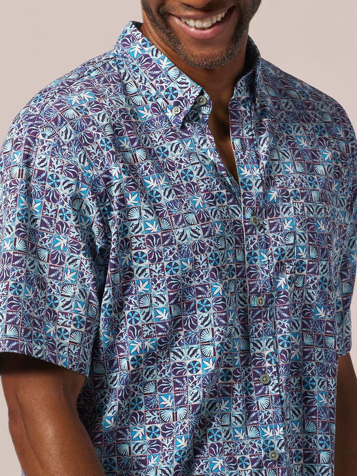 Blue-purple solid UPF shirt with front pocket, worn by man, front view.