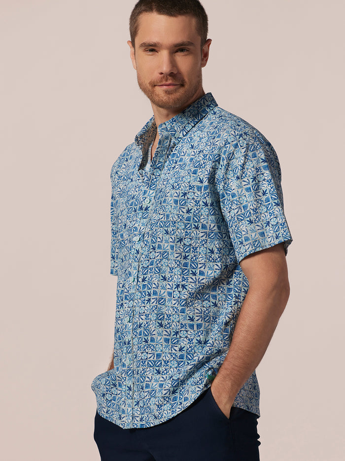 Blue geometric-print quick-dry shirt, front view with hands in pockets