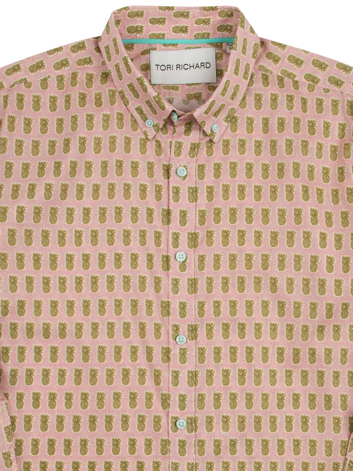 Soft pink shirt with yellow-green pineapple print, long sleeves, front view.