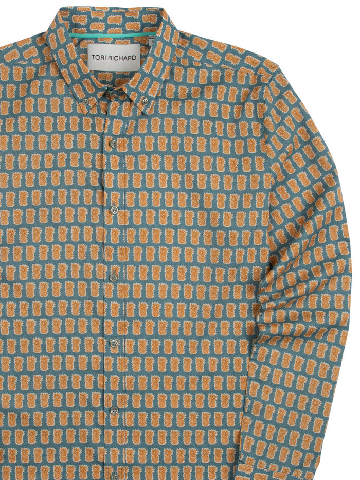White poplin long-sleeve shirt with orange pineapple pattern, button-up front view.