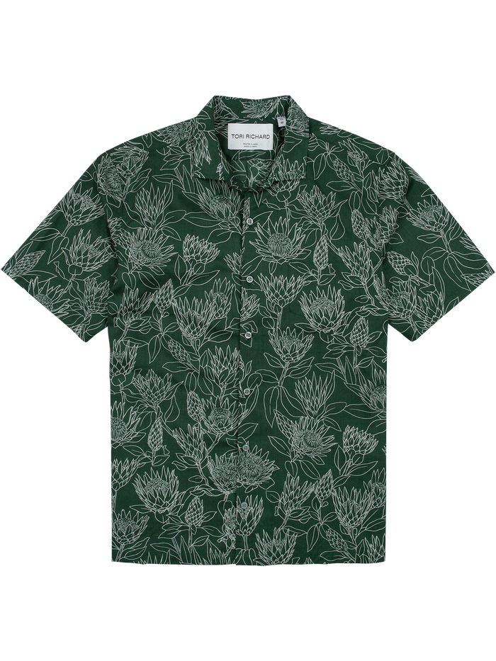 Dark green and white protea-print cotton shirt with button front and collar, front view.